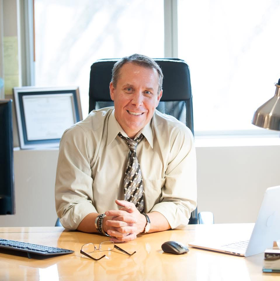 Mark Torbett seated at his desk